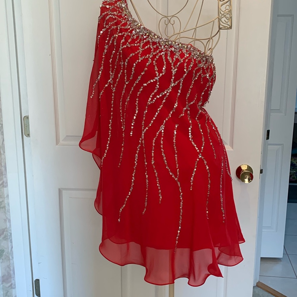 Beautiful red dress with sequence. Wore 1 time in modeling for a fashion show.